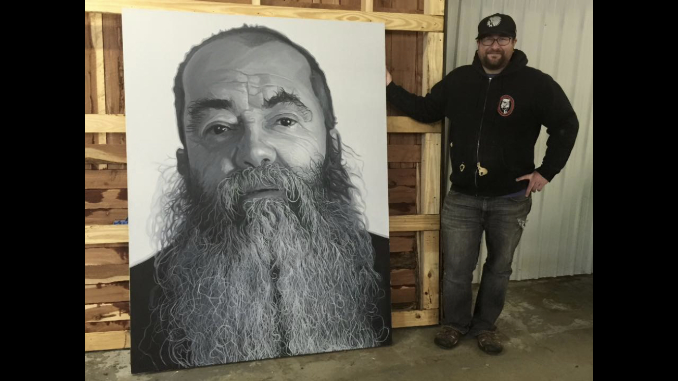 Professor Emmett Dugan standing next to his painting.