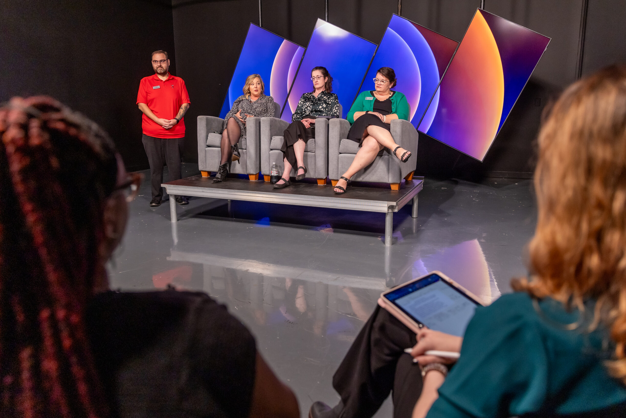 Students at a mock press conference interviewing administration from Vol State Community College.